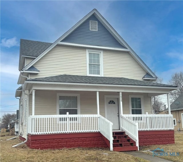 view of front of property featuring a shingled roof and a porch