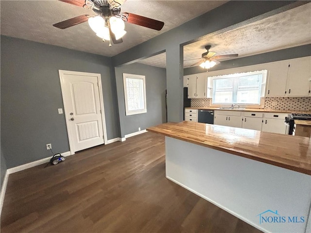 kitchen with white cabinets, stainless steel gas stove, a sink, butcher block countertops, and dishwasher