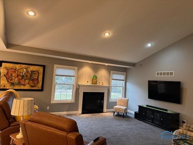 carpeted living room featuring visible vents, baseboards, recessed lighting, a fireplace, and vaulted ceiling