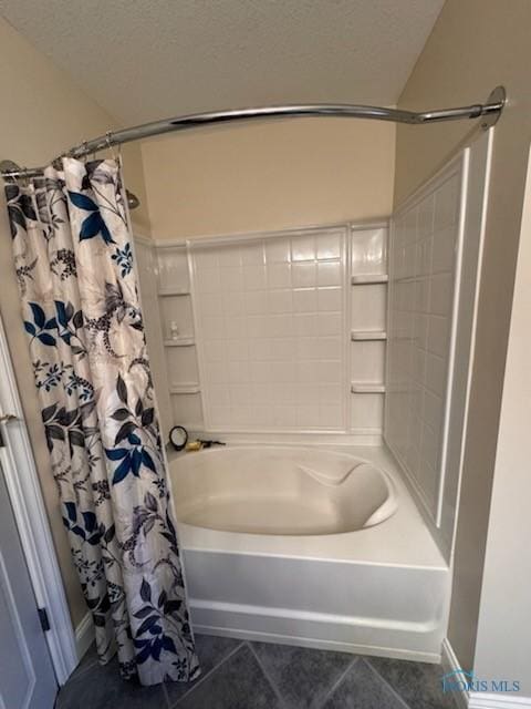 full bath featuring tile patterned floors, a textured ceiling, and shower / tub combo with curtain