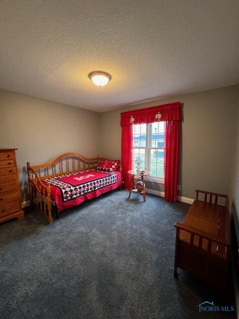 bedroom with carpet flooring, a textured ceiling, and baseboards