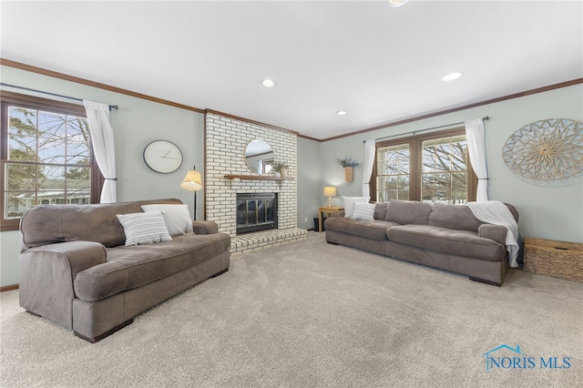 carpeted living area featuring a fireplace, crown molding, and recessed lighting