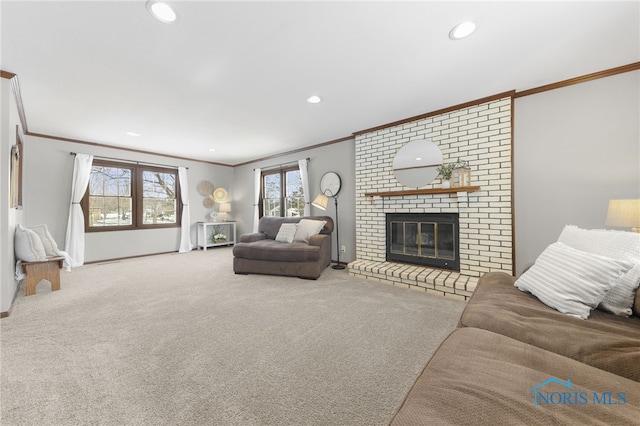 carpeted living room featuring baseboards, ornamental molding, a fireplace, and recessed lighting