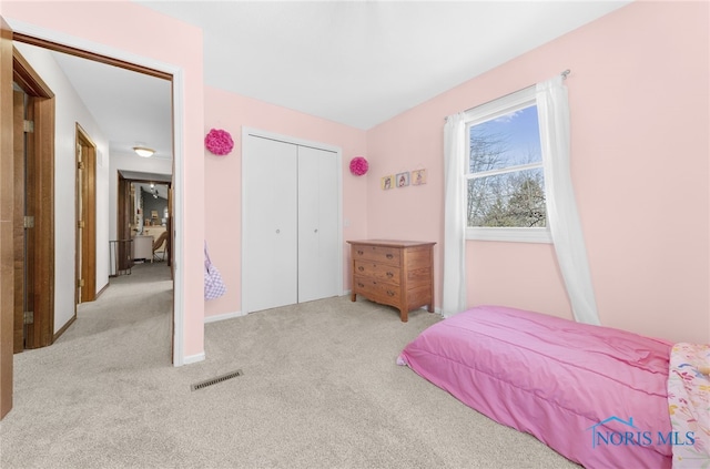 bedroom featuring a closet, carpet, and visible vents