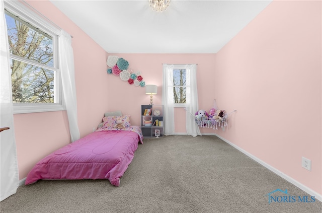 carpeted bedroom featuring baseboards