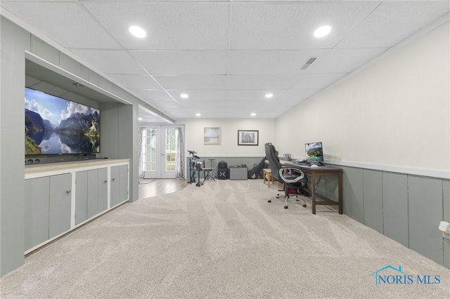 carpeted office with recessed lighting, french doors, wainscoting, and a drop ceiling