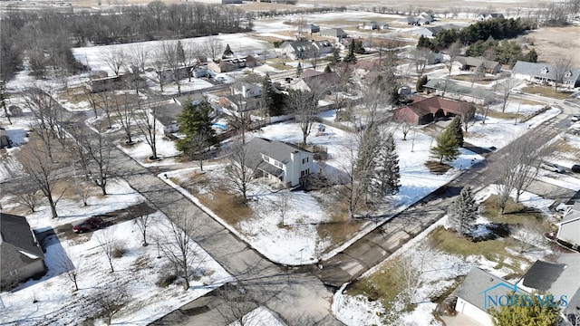 snowy aerial view with a residential view