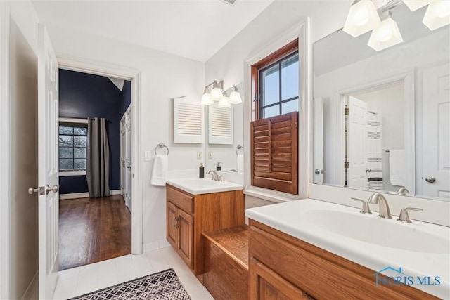 full bath with tile patterned flooring, two vanities, and a sink