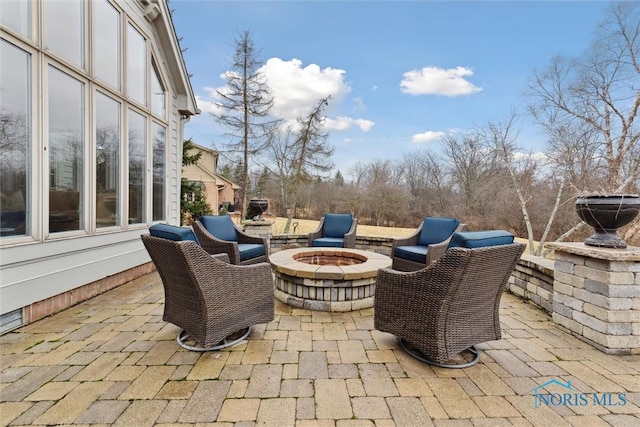 view of patio / terrace featuring an outdoor fire pit