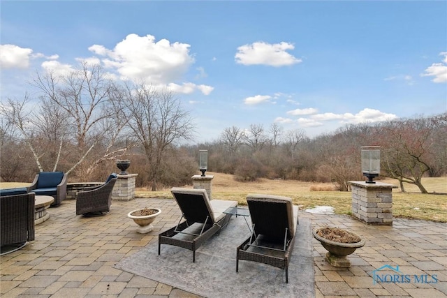 view of patio / terrace featuring a fire pit