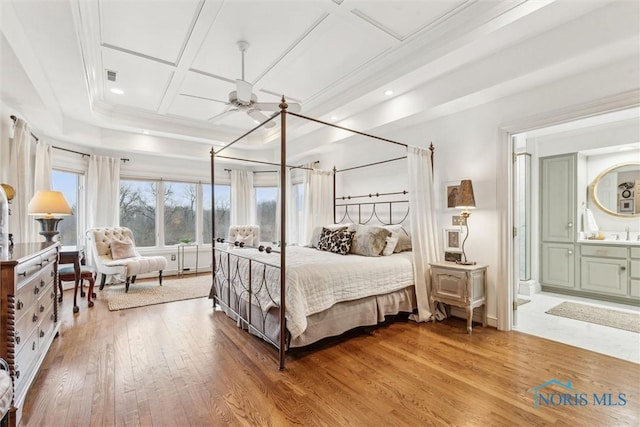 bedroom featuring visible vents, coffered ceiling, wood finished floors, and ensuite bathroom