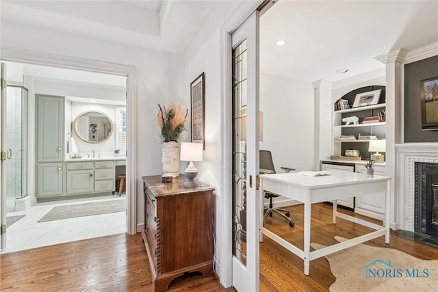 entrance foyer featuring recessed lighting, baseboards, wood finished floors, and a tile fireplace