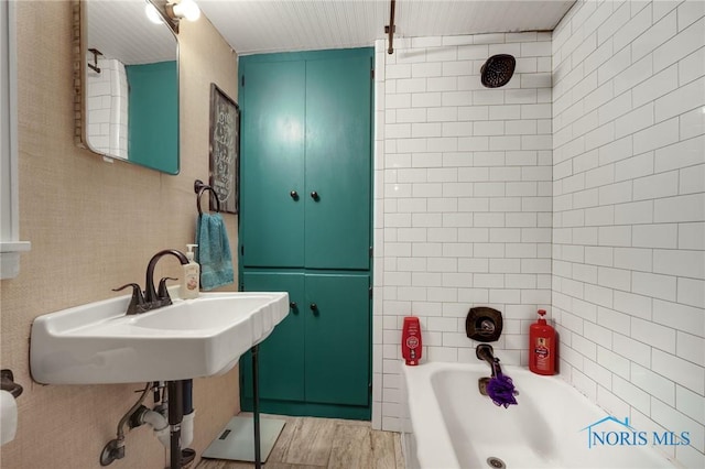 bathroom featuring  shower combination and wood finished floors