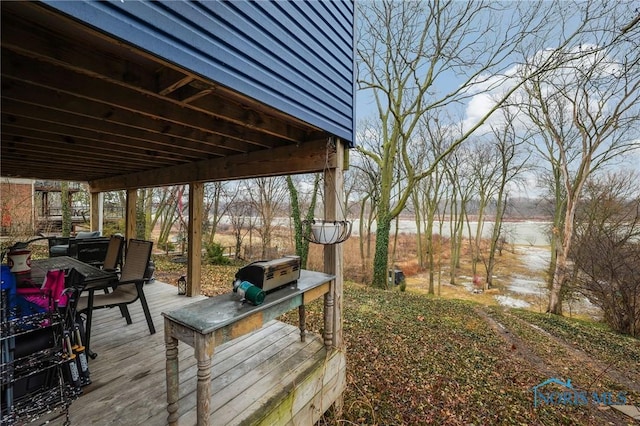 wooden terrace featuring outdoor dining area