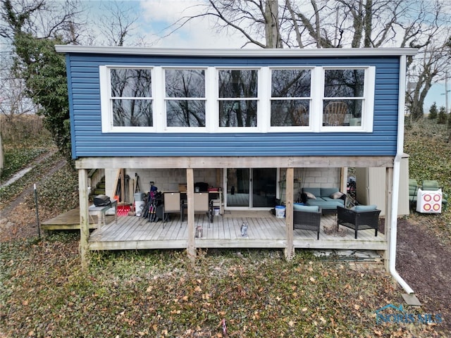 rear view of house with a deck and an outdoor hangout area