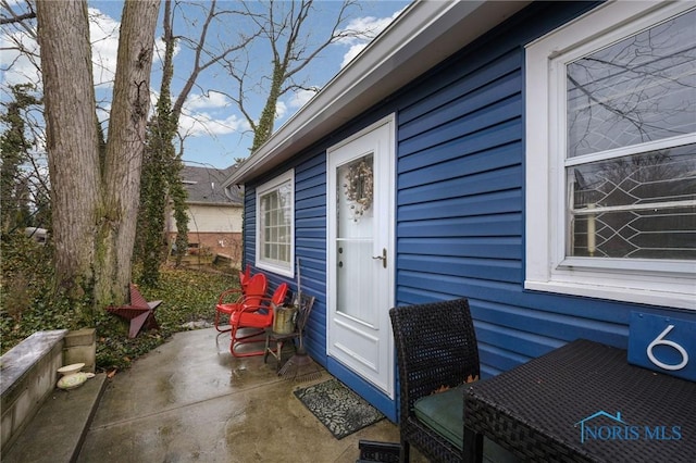 doorway to property with a patio