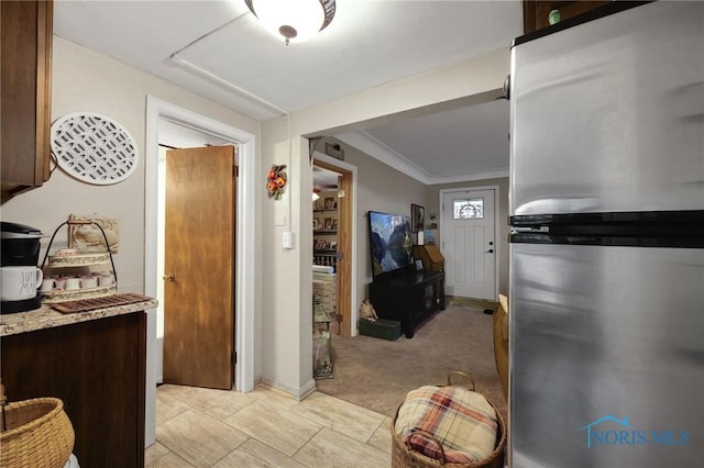 interior space with light carpet and crown molding