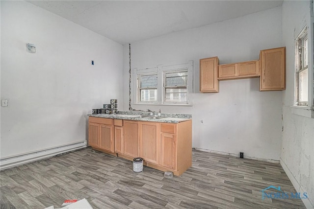 2618 Collingwood Blvd, Toledo, OH 43610 - kitchen with a baseboard heating unit, light wood-type flooring, and light countertops