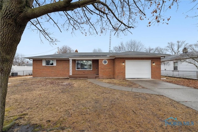 ranch-style home featuring a garage, concrete driveway, brick siding, and fence