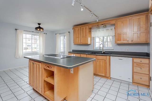 kitchen featuring cooktop, dishwasher, a center island, light floors, and a sink