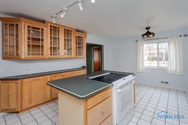 kitchen with electric range, visible vents, a center island, dark countertops, and glass insert cabinets