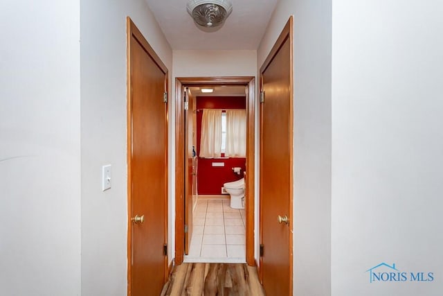 corridor with light wood-style flooring