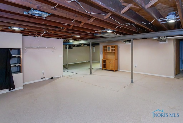 unfinished basement featuring baseboards