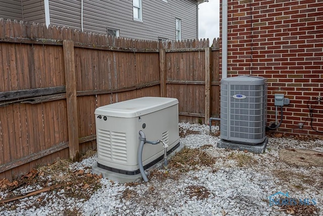 details featuring a power unit, central AC, and fence