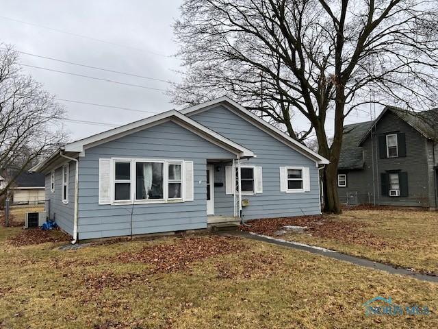 bungalow-style house with a front yard