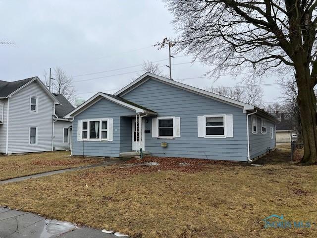 bungalow-style house featuring a front yard