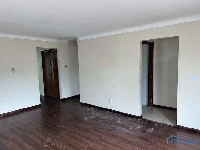 spare room featuring wood finished floors and baseboards