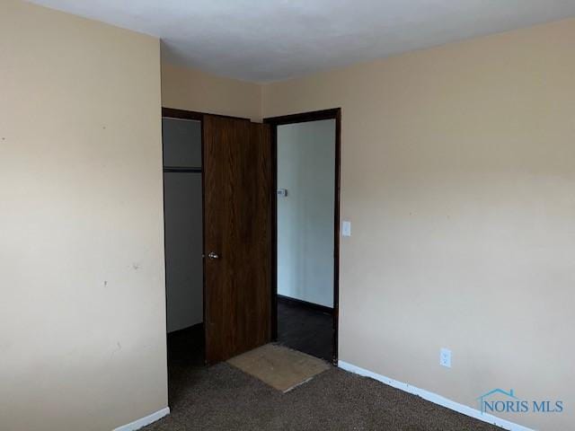 carpeted spare room with baseboards