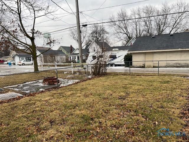 view of yard featuring a residential view and fence