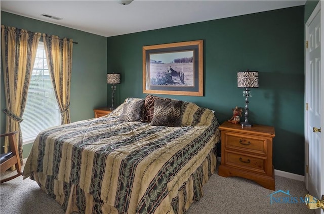 bedroom with carpet, visible vents, and baseboards