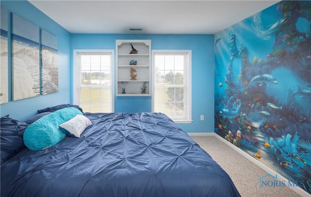 bedroom with baseboards, multiple windows, visible vents, and carpet flooring