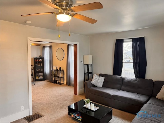 carpeted living area with ceiling fan, visible vents, and baseboards