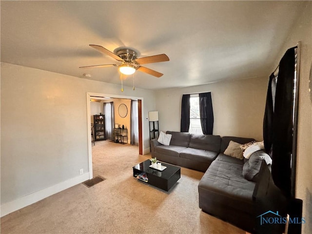 living area featuring carpet floors, visible vents, ceiling fan, and baseboards