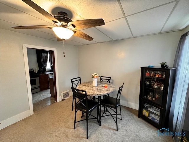 dining area with baseboards, visible vents, a ceiling fan, a drop ceiling, and carpet flooring