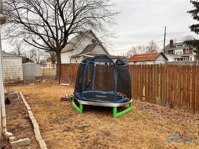 view of jungle gym with a fenced backyard and a trampoline