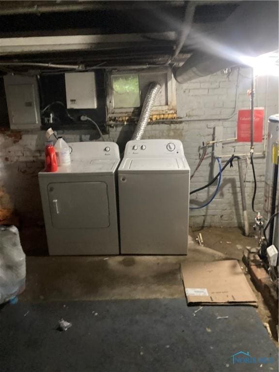 washroom with laundry area, electric panel, and washer and dryer