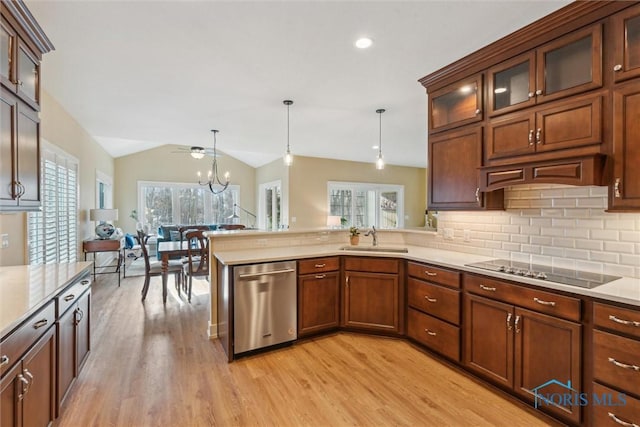 kitchen with black electric stovetop, light countertops, a sink, and stainless steel dishwasher