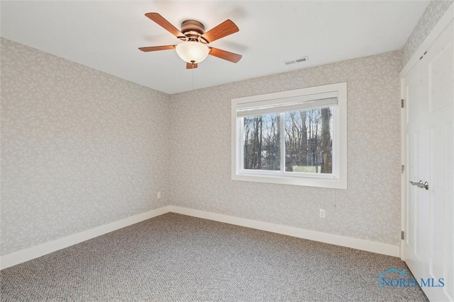 unfurnished bedroom featuring carpet floors, wallpapered walls, and visible vents