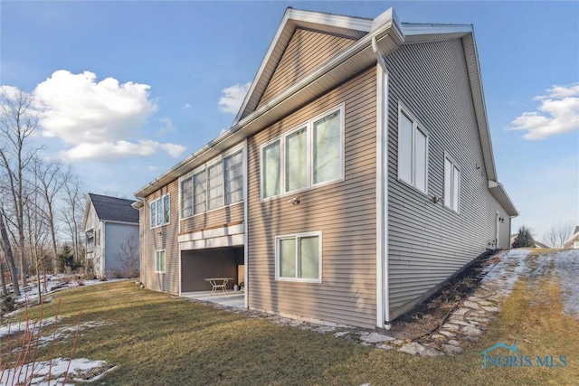 view of home's exterior with a yard and a patio