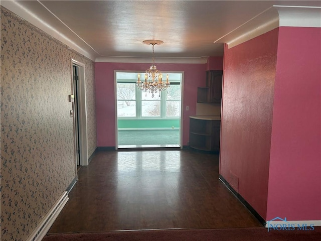 hallway with dark wood-style flooring and an inviting chandelier