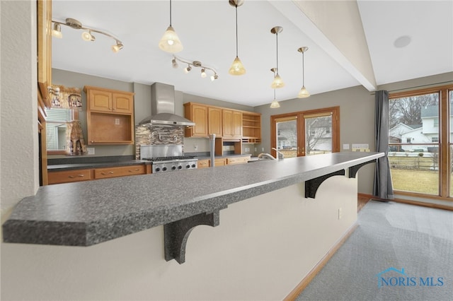 kitchen with open shelves, dark countertops, light carpet, wall chimney range hood, and range