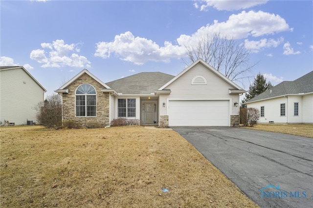 ranch-style house featuring aphalt driveway, a front yard, stone siding, and an attached garage