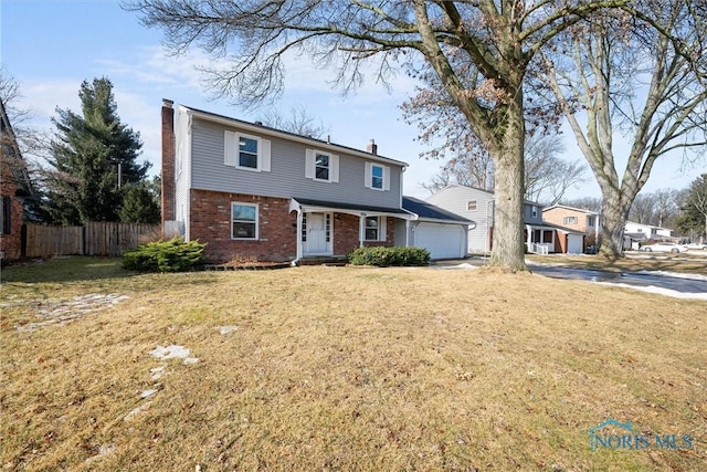 view of front facade with brick siding, a chimney, an attached garage, fence, and a front lawn