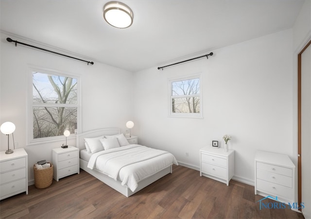 bedroom featuring baseboards and wood finished floors