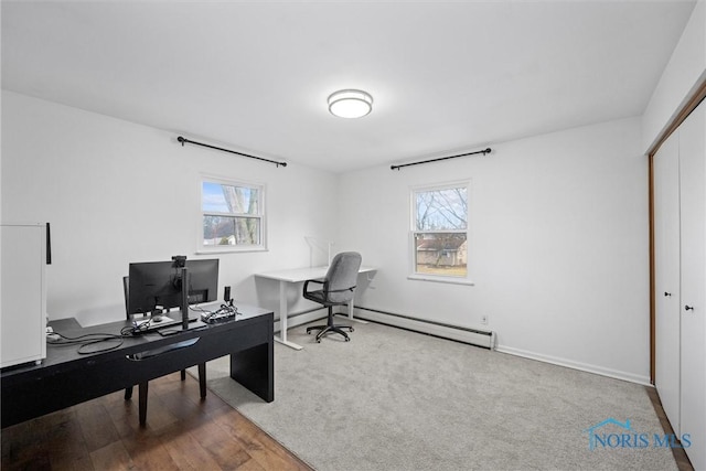 office space featuring baseboard heating, plenty of natural light, and wood finished floors