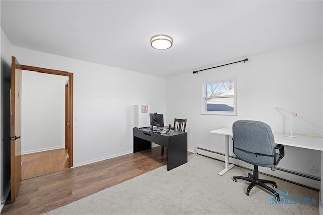 office with a baseboard heating unit, baseboards, and wood finished floors